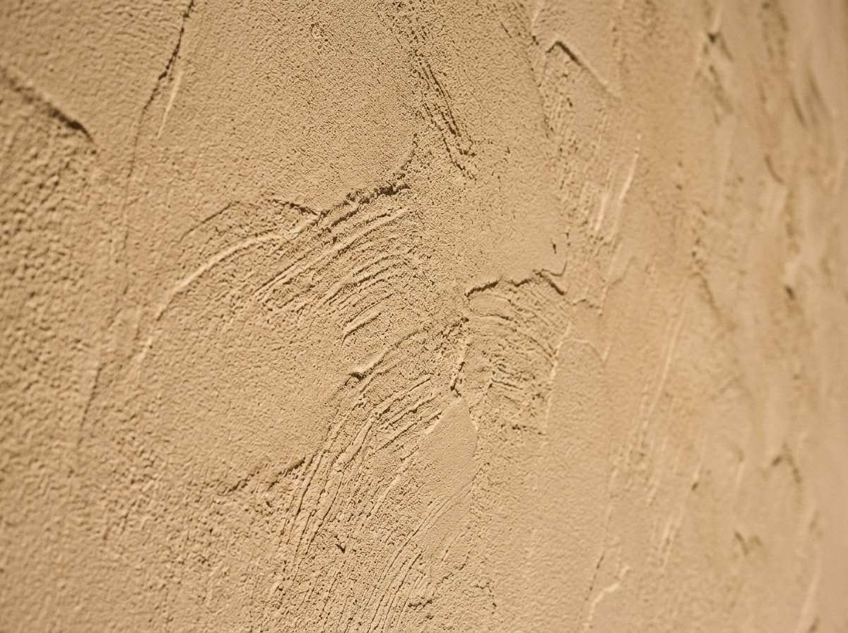 Exterior stucco home repainted with desert-grade elastomeric coating in Bullhead City